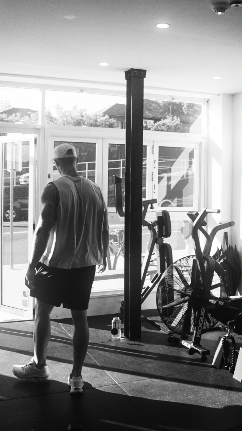 A member walking past the air bike in afternoon sun