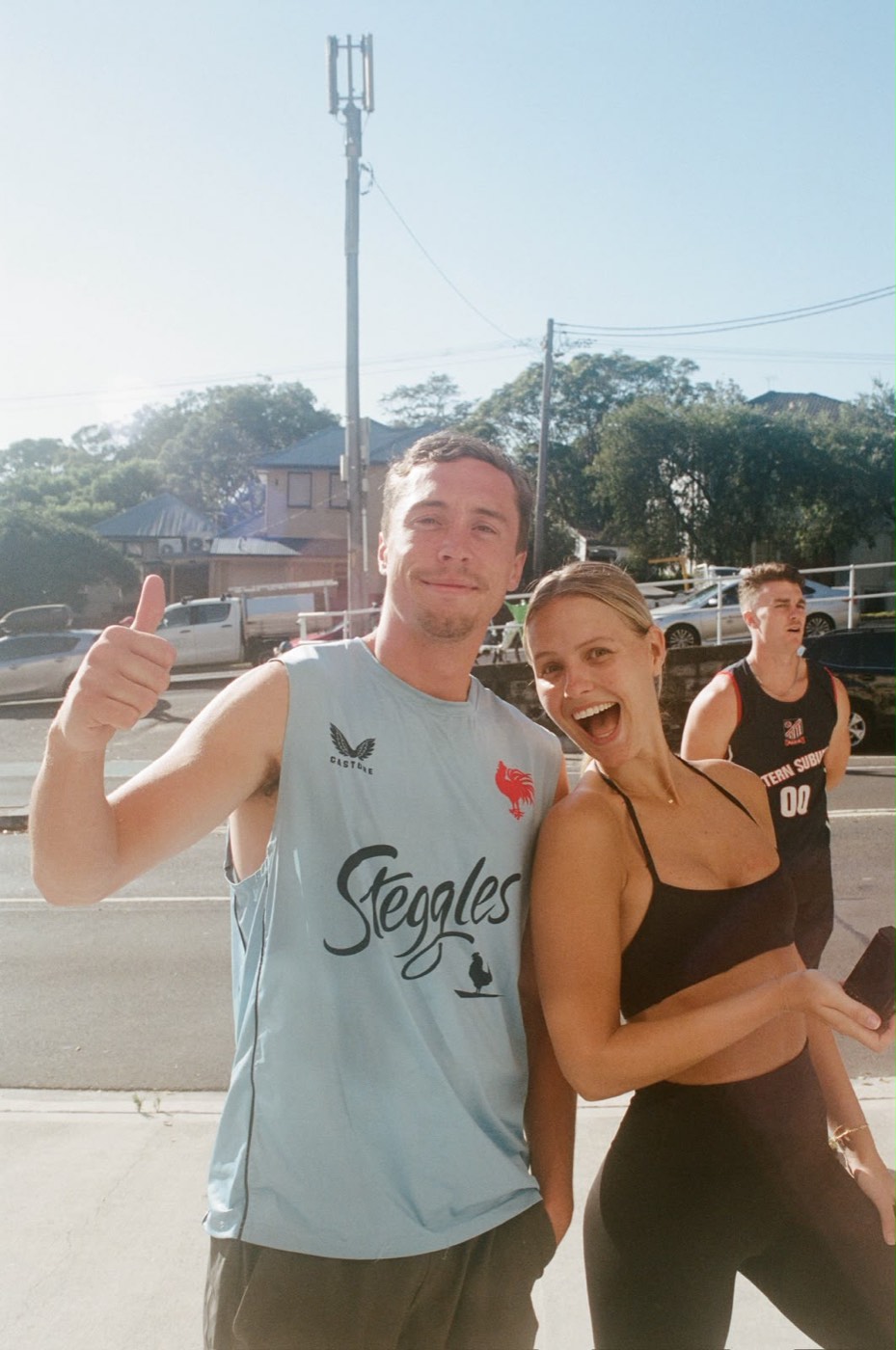 Two members outside the studio after class, one giving a thumbs up